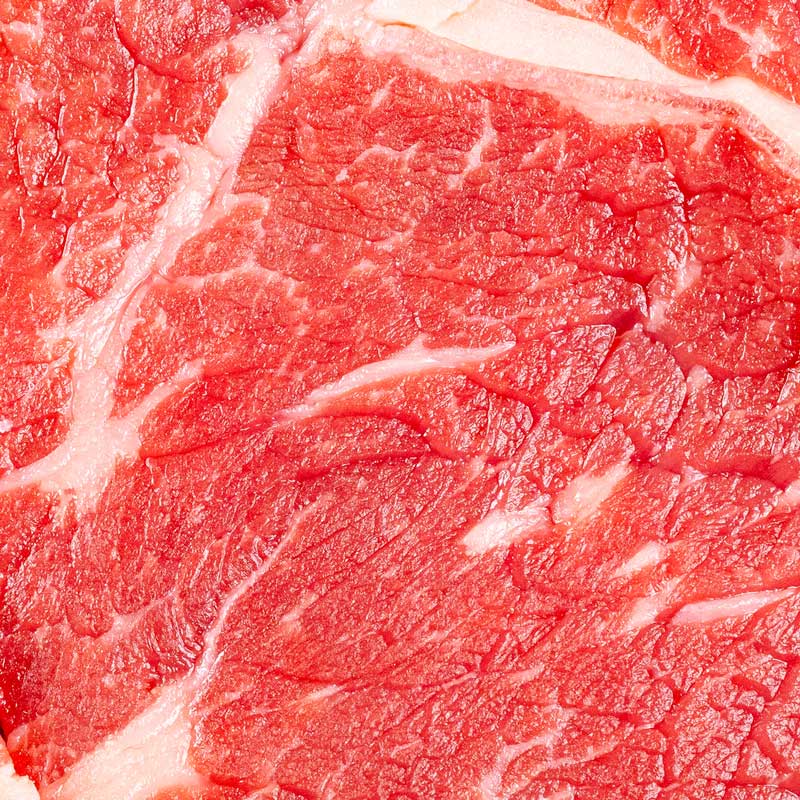 Premium Black Angus Ribeye Steak von TAURBULL, Nahaufnahme von oben aufgenommen, zeigt perfekte Marmorierung