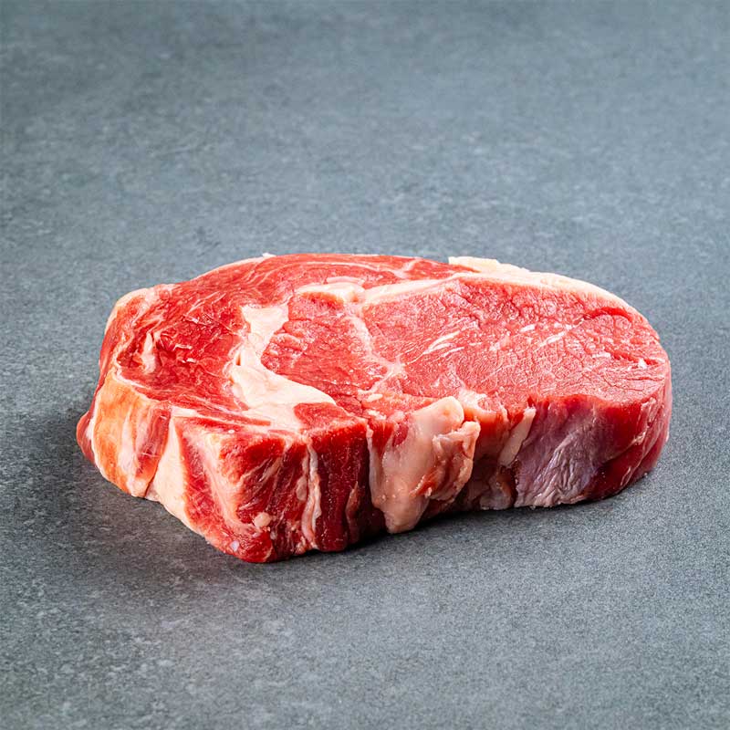 Premium Black Angus Ribeye Steak von TAURBULL, Black Angus, roh, perfekt marmoriert.