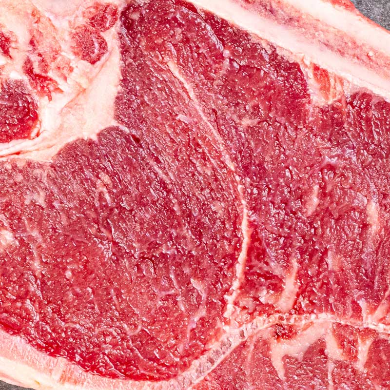 Sirloin Steak von TAURBULL, Premium Black Angus Steak, roh, Draufsicht betont die kräftige Fleischstruktur und Marmorierung des Fleisches.